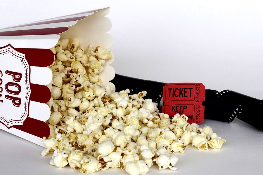 this image shows popcorn, movie ticket and show reel