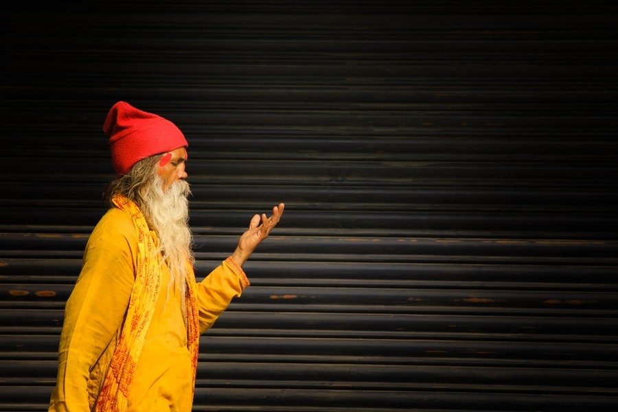 sadhu standing beside roller shutter
